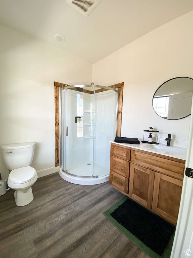 3213 N 4900 W, Malad City, ID 83252 - bathroom featuring toilet, vanity, a shower with shower door, and hardwood / wood-style flooring