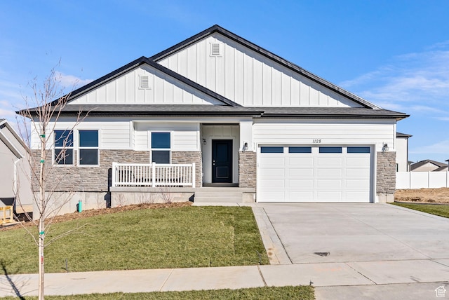 view of front of home with a porch, a front yard, and a garage