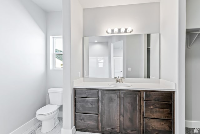 bathroom with tile floors, toilet, and vanity