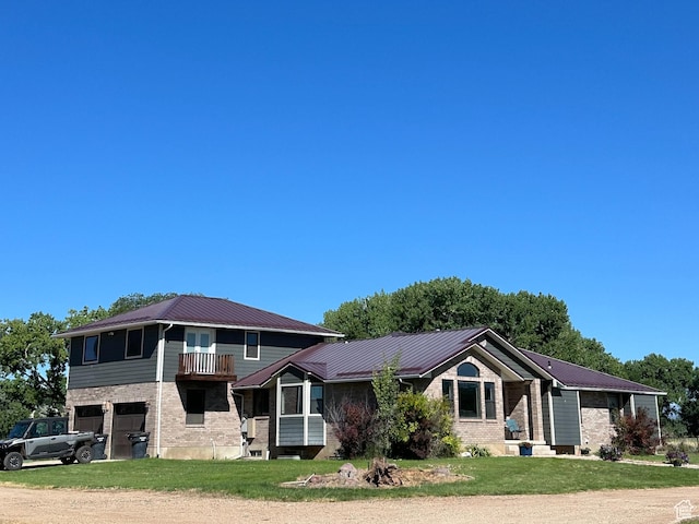 view of front of house with a balcony, a garage, and a front yard