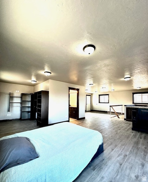 bedroom featuring hardwood / wood-style flooring and a textured ceiling