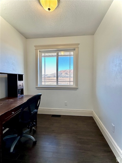 office space featuring a textured ceiling and dark hardwood / wood-style flooring