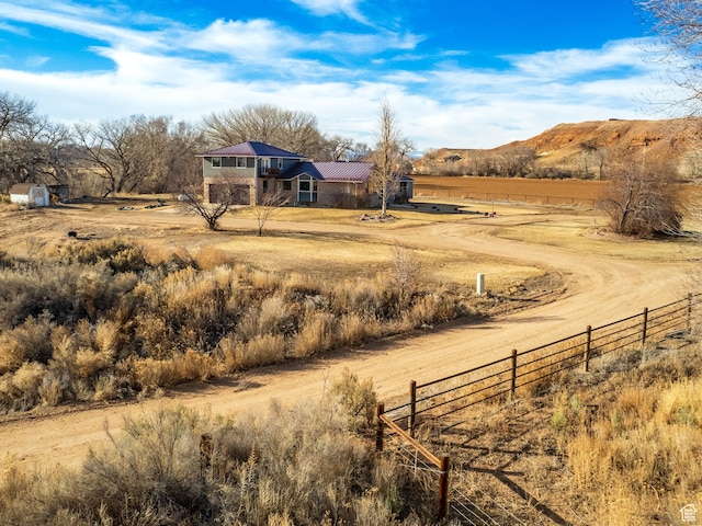 view of yard featuring a mountain view and a rural view
