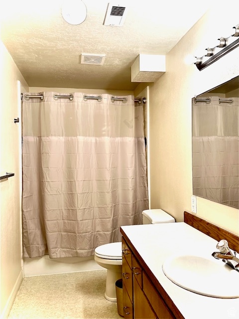 full bathroom featuring shower / bath combo with shower curtain, a textured ceiling, toilet, and vanity