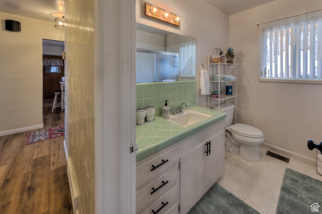 165 E 200 S, Monticello, UT 84535 - bathroom featuring tasteful backsplash, hardwood / wood-style floors, large vanity, and toilet