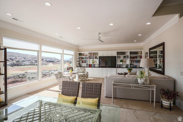 836 E St James Ln, St George, UT 84790 - living room featuring built in shelves, a mountain view, ceiling fan, and crown molding