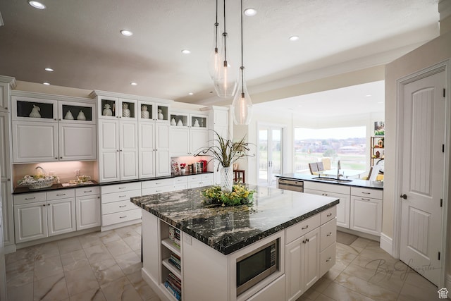 836 E St James Ln, St George, UT 84790 - kitchen featuring pendant lighting, a kitchen island, stainless steel appliances, light tile flooring, and white cabinetry