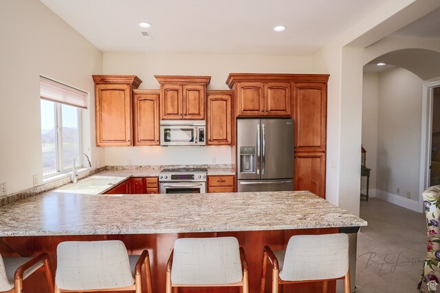 836 E St James Ln, St George, UT 84790 - kitchen featuring kitchen peninsula, a kitchen bar, appliances with stainless steel finishes, and sink