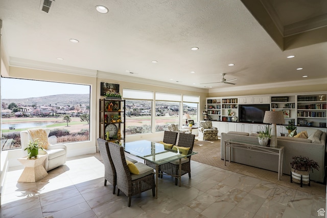 836 E St James Ln, St George, UT 84790 - tiled dining area featuring a mountain view, built in features, a textured ceiling, and ceiling fan