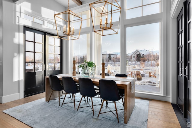 3297 W Blue Springs Ln, Bluffdale, UT 84065 - dining area with light hardwood / wood-style flooring, beamed ceiling, and a chandelier