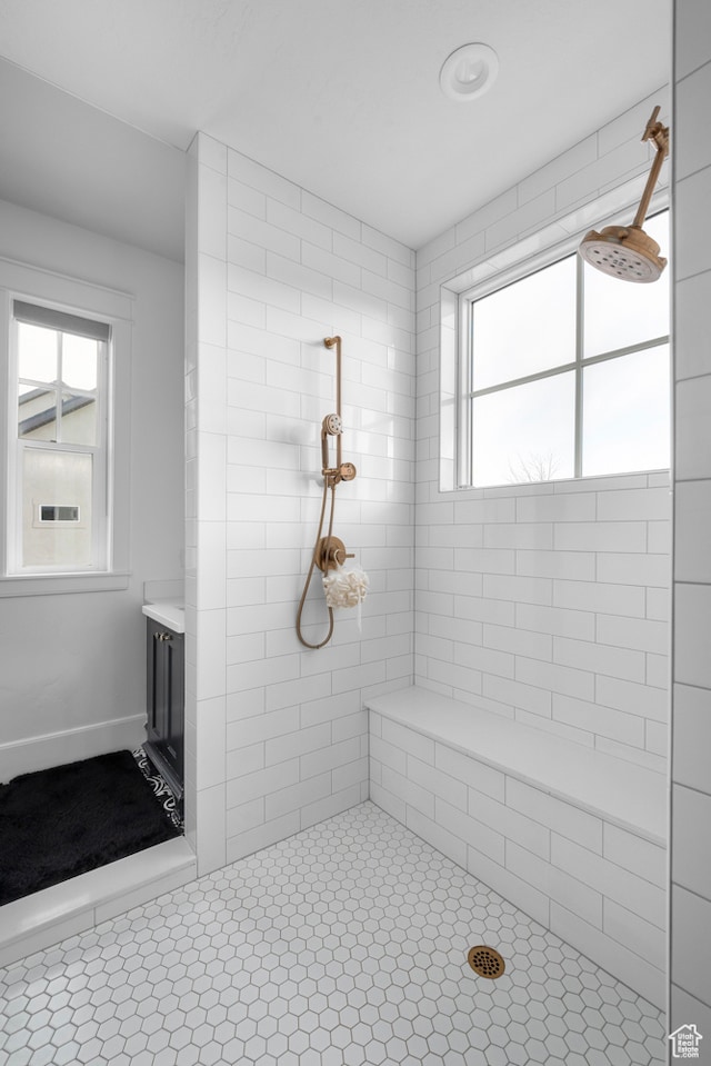 3297 W Blue Springs Ln, Bluffdale, UT 84065 - bathroom with vanity, a tile shower, and plenty of natural light