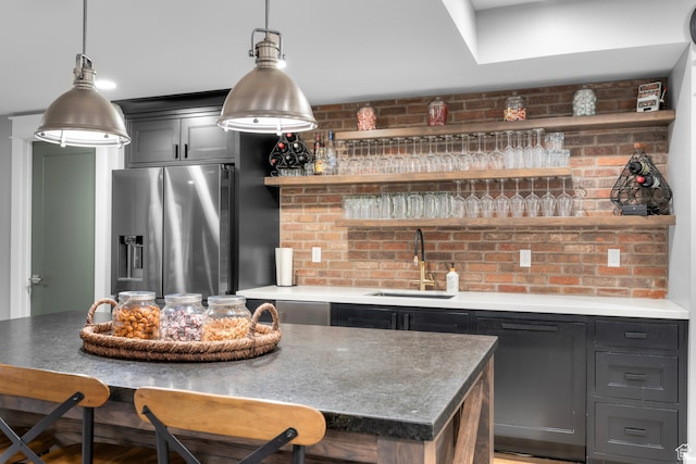3297 W Blue Springs Ln, Bluffdale, UT 84065 - kitchen with a center island, stainless steel fridge, a kitchen bar, and sink