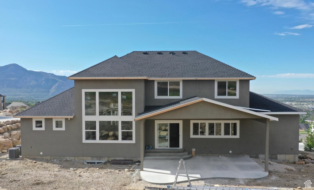 173 E 4100 N Unit 172, North Ogden, UT 84414 - rear view of house featuring central AC, a patio area, a shingled roof, a mountain view, and stucco siding
