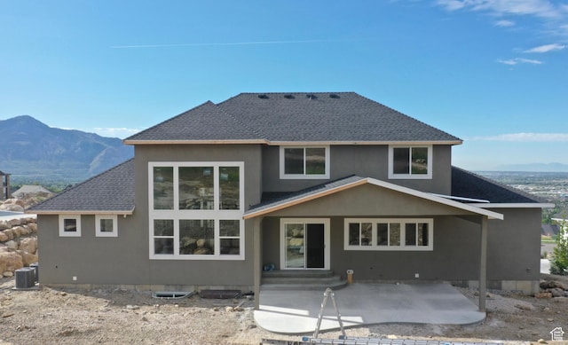 173 E 4100 N Unit 172, North Ogden, UT 84414 - rear view of house featuring central AC, a patio area, a shingled roof, a mountain view, and stucco siding