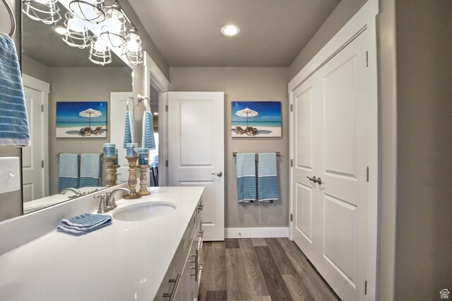 55 W Buttercup Ln Unit 26, Garden City, UT 84028 - bathroom featuring hardwood / wood-style floors, a notable chandelier, and vanity