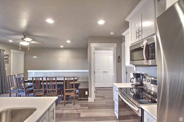 55 W Buttercup Ln Unit 26, Garden City, UT 84028 - kitchen featuring appliances with stainless steel finishes, ceiling fan, dark wood-type flooring, and white cabinets