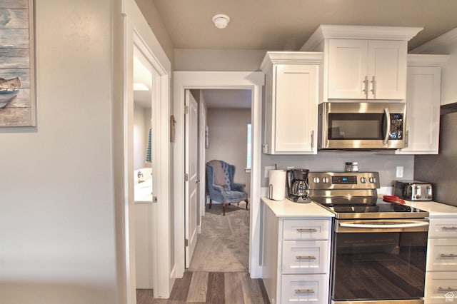 55 W Buttercup Ln Unit 26, Garden City, UT 84028 - kitchen with white cabinets, stainless steel appliances, and hardwood / wood-style flooring