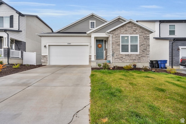 view of front of property with a front yard and a garage