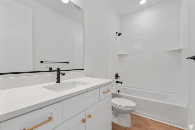 full bathroom featuring toilet, wood finished floors, vanity, shower / washtub combination, and recessed lighting