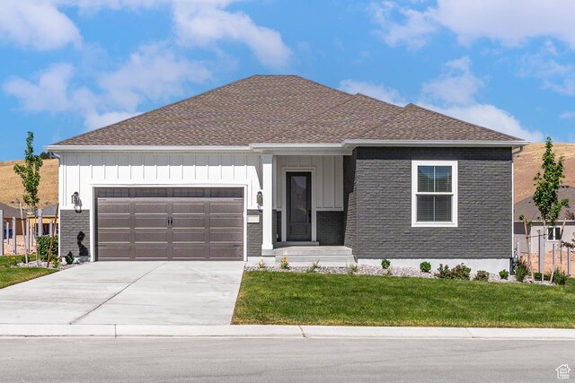 1260 Crest Dale Ln, Santaquin, UT 84655 - view of front of house featuring a front yard, a garage, board and batten siding, and concrete driveway