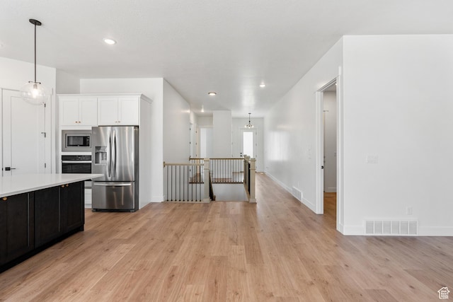 1260 Crest Dale Ln, Santaquin, UT 84655 - kitchen featuring light countertops, stainless steel appliances, light wood-style floors, and visible vents