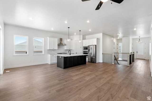 1260 Crest Dale Ln, Santaquin, UT 84655 - kitchen featuring open floor plan, light countertops, wall chimney range hood, and appliances with stainless steel finishes