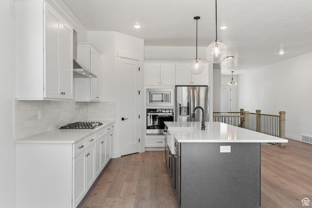 1260 Crest Dale Ln, Santaquin, UT 84655 - kitchen featuring light countertops, light wood-style flooring, stainless steel appliances, tasteful backsplash, and white cabinetry