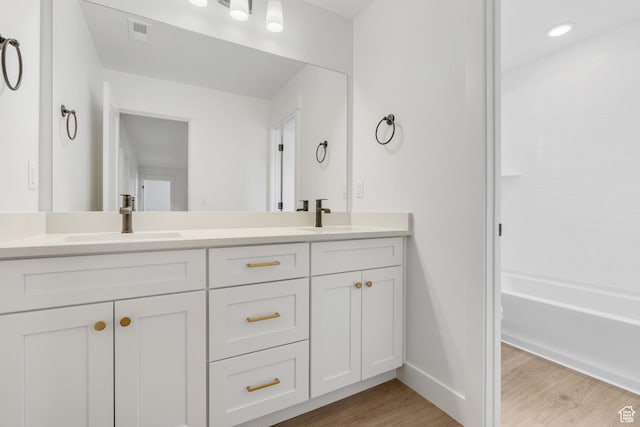 1263 Crest Dale Ln, Santaquin, UT 84655 - full bath featuring visible vents, a sink, double vanity, and wood finished floors