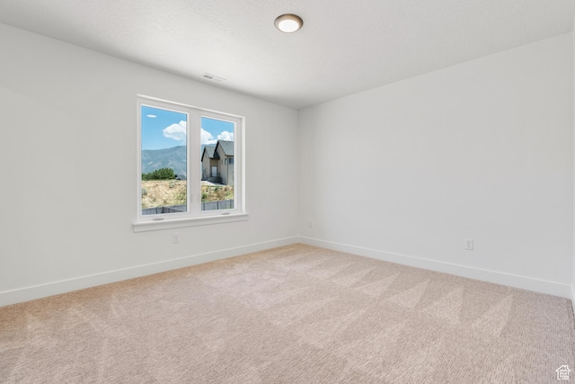 1263 Crest Dale Ln, Santaquin, UT 84655 - empty room with visible vents, light carpet, baseboards, and a textured ceiling