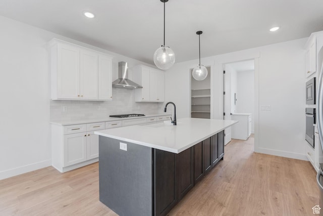 1263 Crest Dale Ln, Santaquin, UT 84655 - kitchen featuring light countertops, wall chimney exhaust hood, appliances with stainless steel finishes, white cabinetry, and a sink