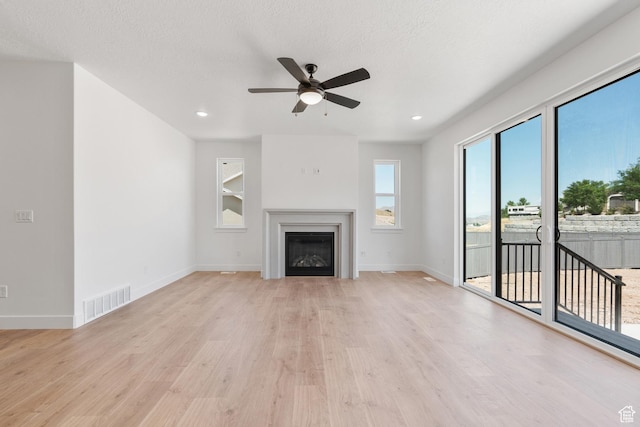 1263 Crest Dale Ln, Santaquin, UT 84655 - unfurnished living room featuring baseboards, light wood-style flooring, visible vents, and a ceiling fan