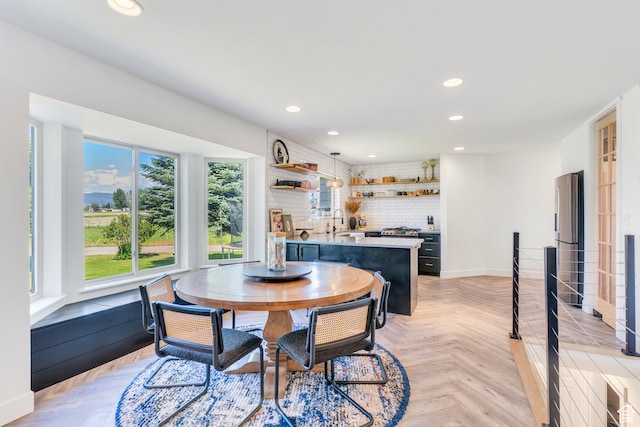 dining room with sink and light parquet flooring