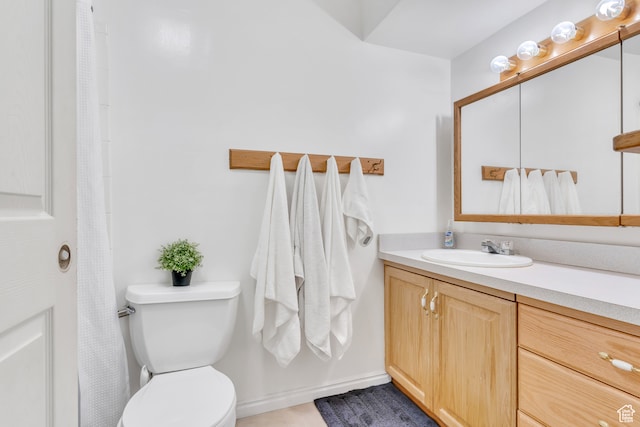 bathroom with toilet and vanity with extensive cabinet space