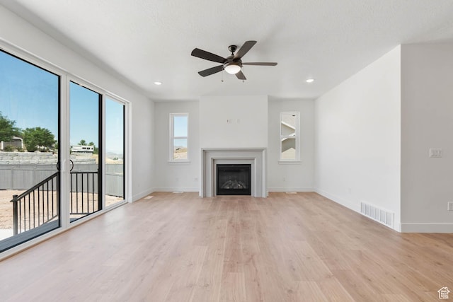 1208 W View Dr S, Santaquin, UT 84655 - unfurnished living room featuring a ceiling fan, wood finished floors, a glass covered fireplace, and recessed lighting