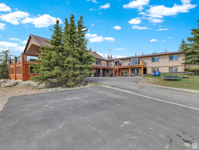 1271 E Oakridge Rd S, Park City, UT 84098 - view of front of home with metal roof, stairway, a trampoline, and a wooden deck