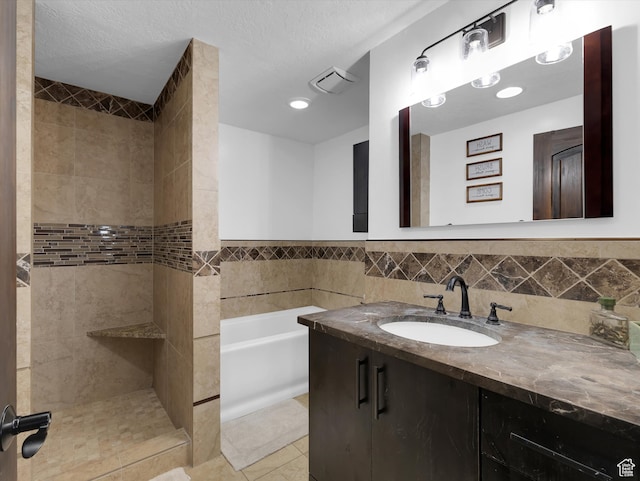 1271 E Oakridge Rd S, Park City, UT 84098 - bathroom with a garden tub, tile patterned flooring, visible vents, tile walls, and a tile shower