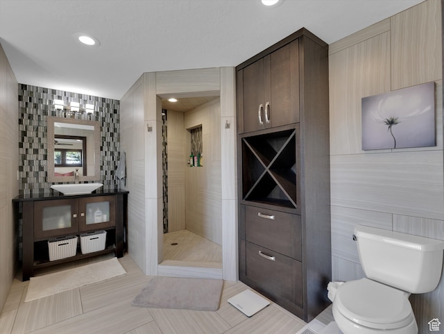1271 E Oakridge Rd S, Park City, UT 84098 - bathroom with a stall shower, toilet, tile patterned flooring, vanity, and tile walls