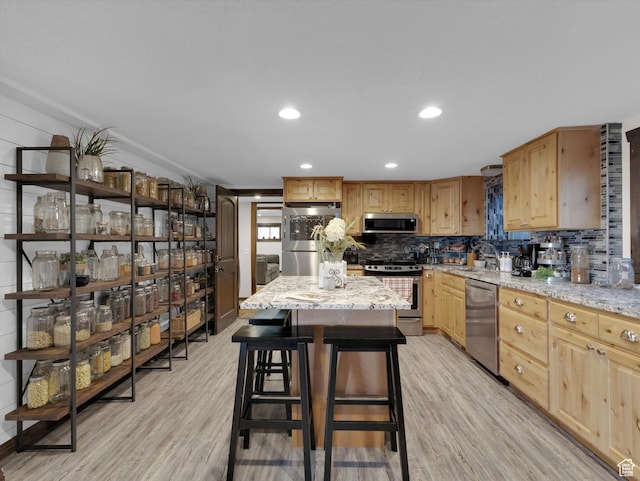 1271 E Oakridge Rd S, Park City, UT 84098 - kitchen with stainless steel appliances, a center island, a sink, and light stone counters