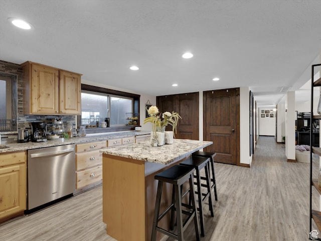 1271 E Oakridge Rd S, Park City, UT 84098 - kitchen with a breakfast bar, light wood finished floors, stainless steel dishwasher, a kitchen island, and light stone countertops