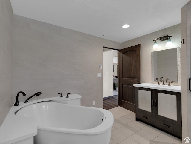 1271 E Oakridge Rd S, Park City, UT 84098 - bathroom featuring a freestanding tub, tile walls, vanity, and tile patterned floors