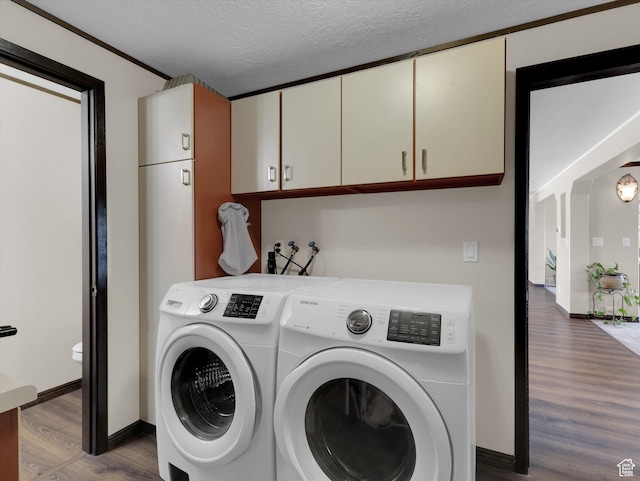 1271 E Oakridge Rd S, Park City, UT 84098 - washroom with a textured ceiling, washing machine and dryer, wood finished floors, baseboards, and cabinet space
