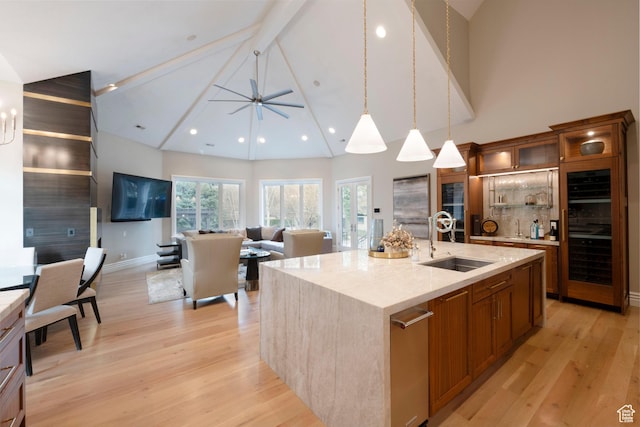 2227 E 5340 S, Holladay, UT 84117 - kitchen with a center island with sink, light wood-style flooring, a sink, pendant lighting, and brown cabinets