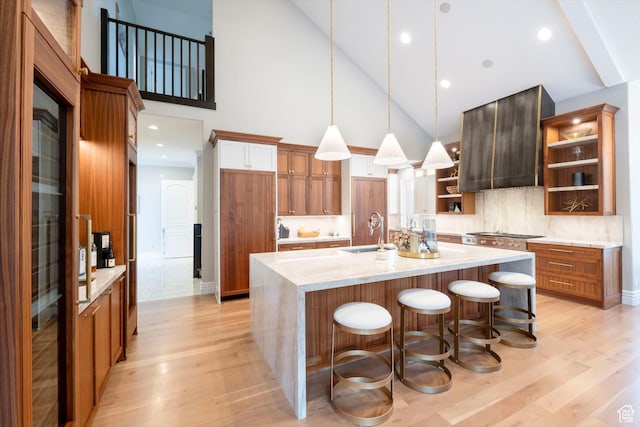 2227 E 5340 S, Holladay, UT 84117 - kitchen with brown cabinets, open shelves, a sink, a spacious island, and light wood-style floors