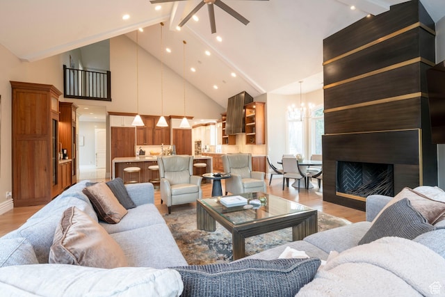 2227 E 5340 S, Holladay, UT 84117 - living room with recessed lighting, ceiling fan with notable chandelier, high vaulted ceiling, and light wood-style flooring