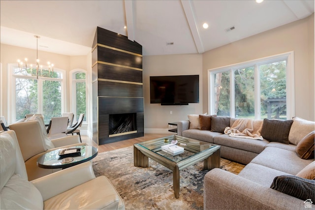 2227 E 5340 S, Holladay, UT 84117 - living room with visible vents, wood finished floors, a large fireplace, an inviting chandelier, and vaulted ceiling with beams