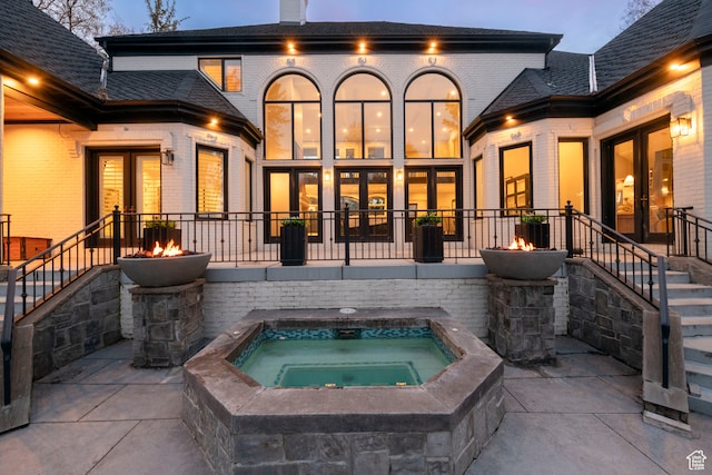 2227 E 5340 S, Holladay, UT 84117 - rear view of house with brick siding, an outdoor fire pit, a chimney, a patio area, and an in ground hot tub