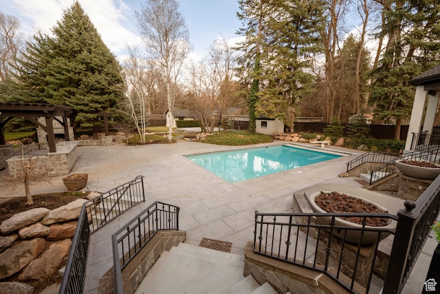 2227 E 5340 S, Holladay, UT 84117 - outdoor pool featuring a patio area, a fenced backyard, a fire pit, and an outdoor structure