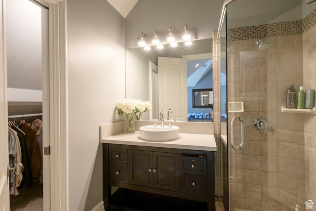 2227 E 5340 S, Holladay, UT 84117 - bathroom with a walk in closet, a stall shower, vanity, and vaulted ceiling