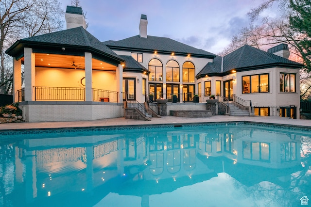 2227 E 5340 S, Holladay, UT 84117 - pool at dusk with a patio area, an outdoor pool, french doors, and a ceiling fan