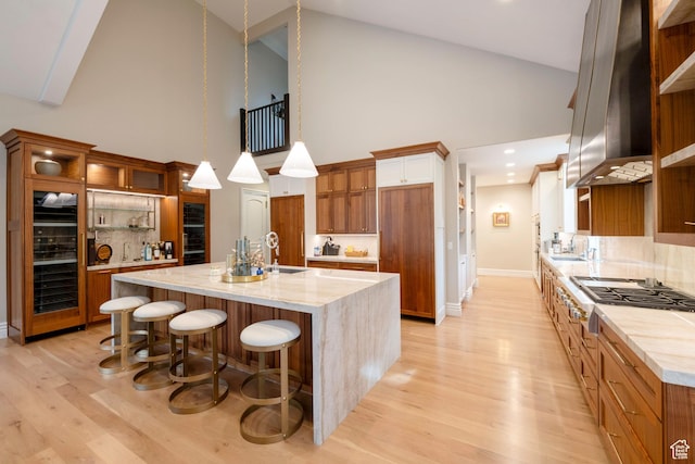 2227 E 5340 S, Holladay, UT 84117 - kitchen featuring beverage cooler, stainless steel gas stovetop, exhaust hood, and a sink